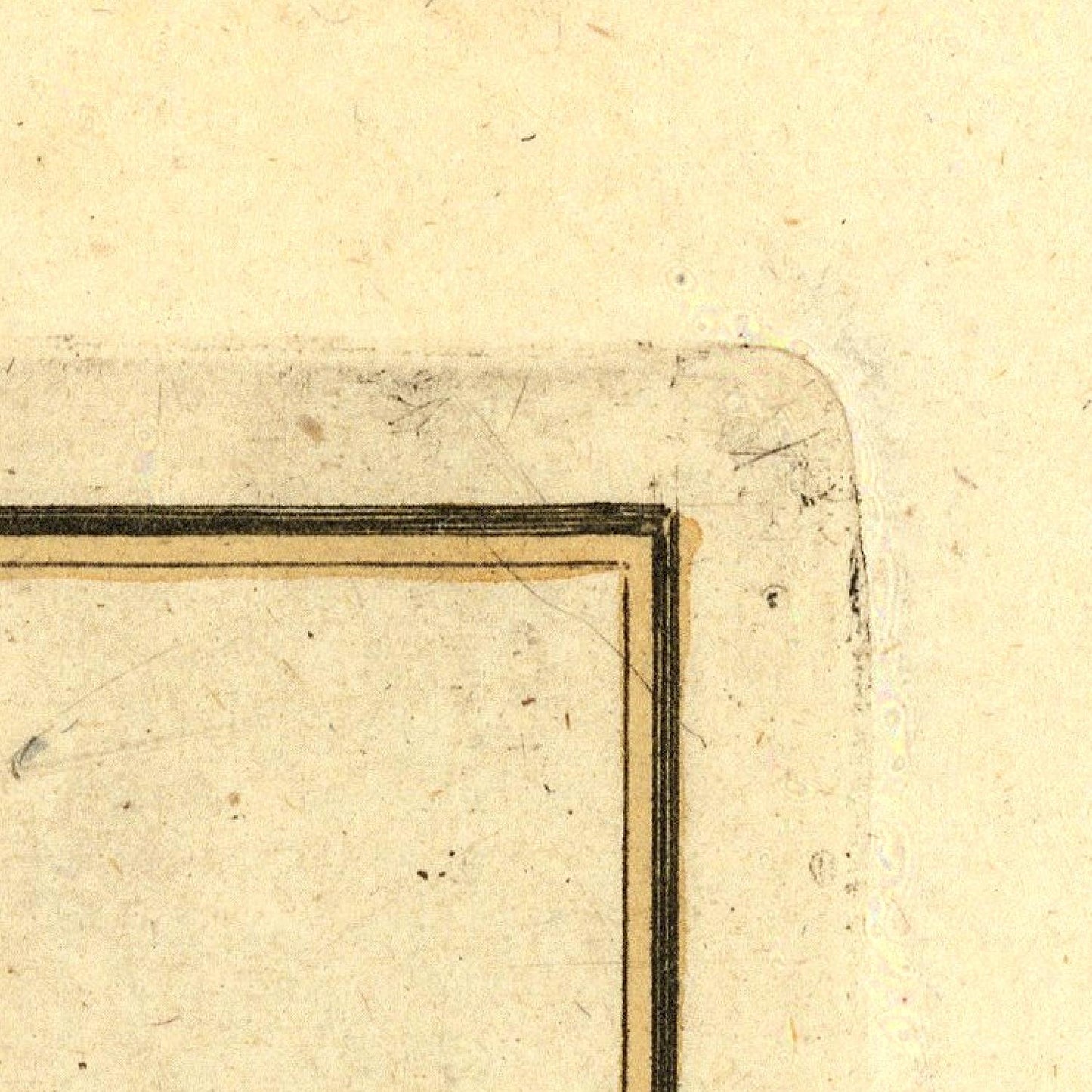 Corner of a vintage document with a gold border on beige paper