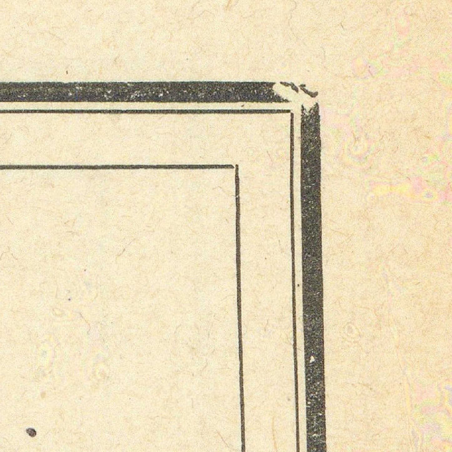 Corner of a book with black border on beige paper