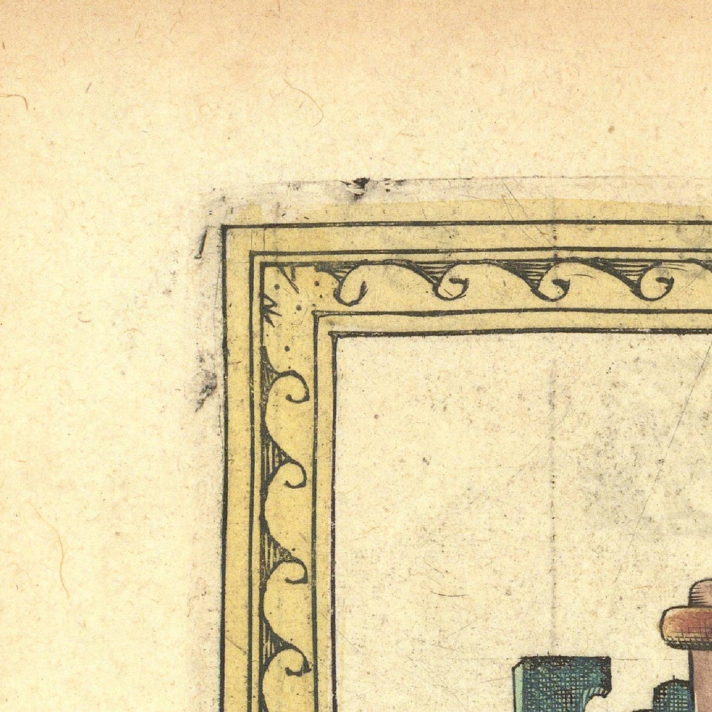 Decorative corner of a vintage map with intricate border design on beige paper.