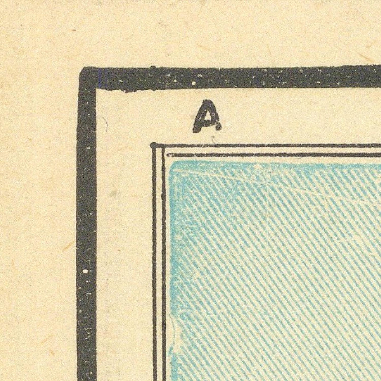 Corner of a vintage card with a blue textured area and letter 'A' on a beige background
