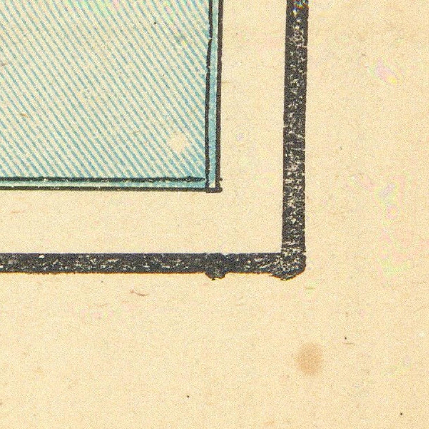 Corner of a vintage document with a green rectangular section on beige paper.