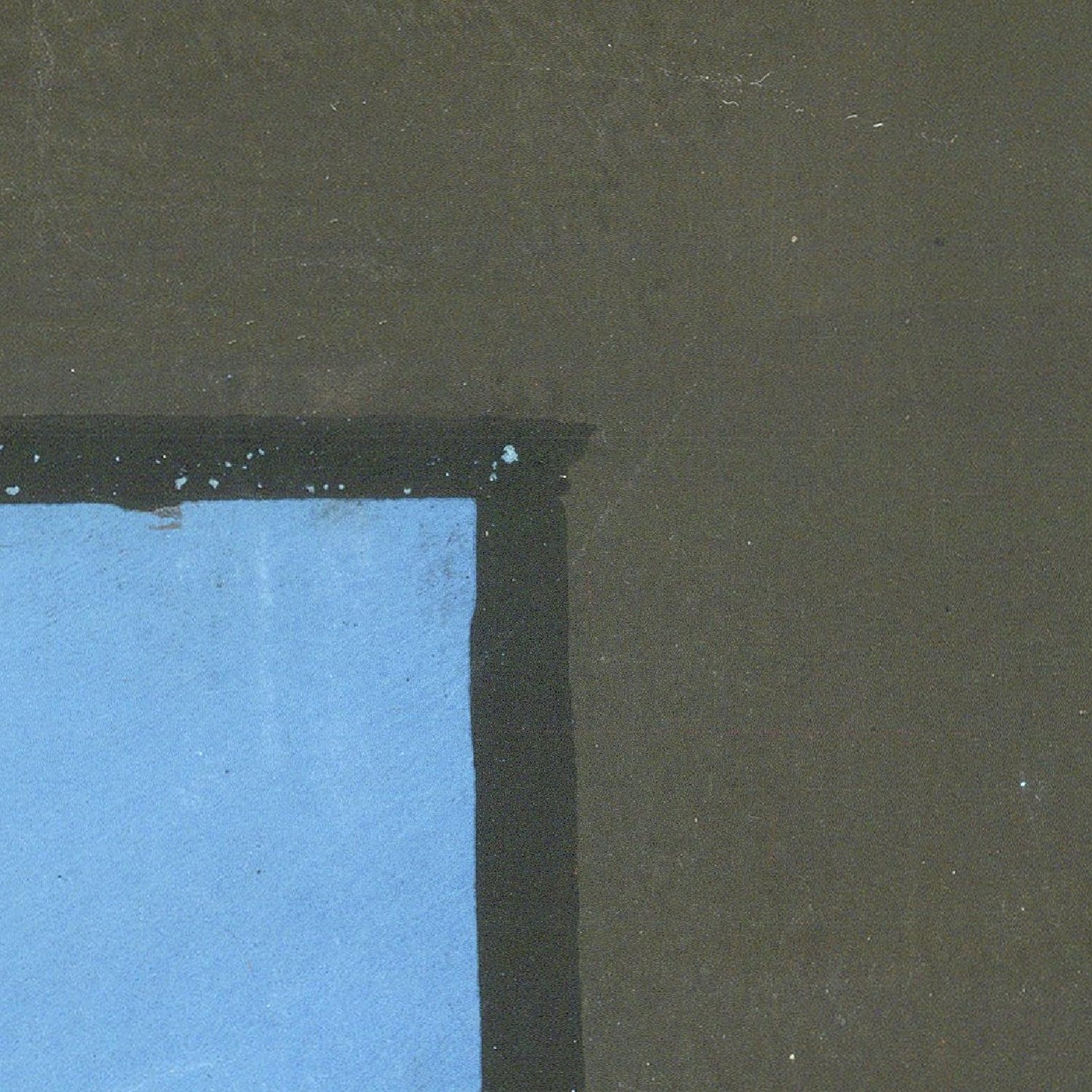 Partial view of a blue object against a dark green background