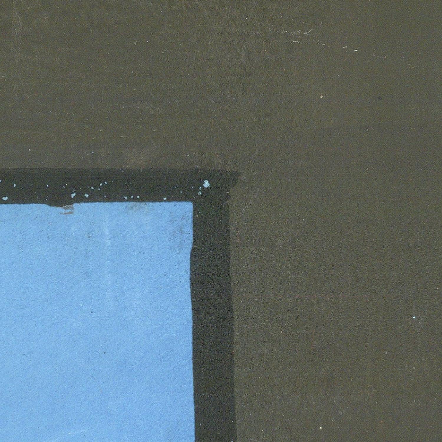 Partial view of a blue object against a dark green background
