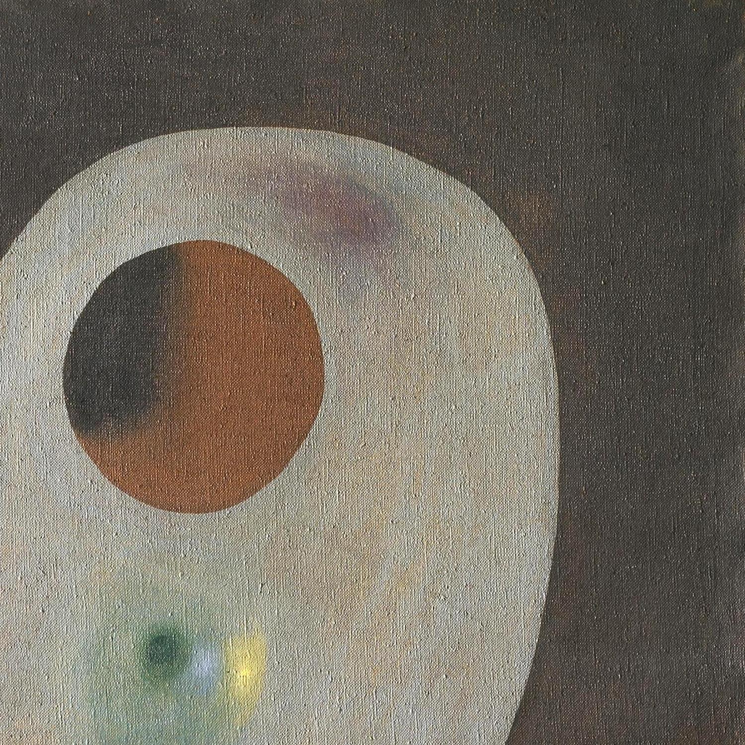 Abstract art with a large circular shape and smaller colored shapes on a dark background