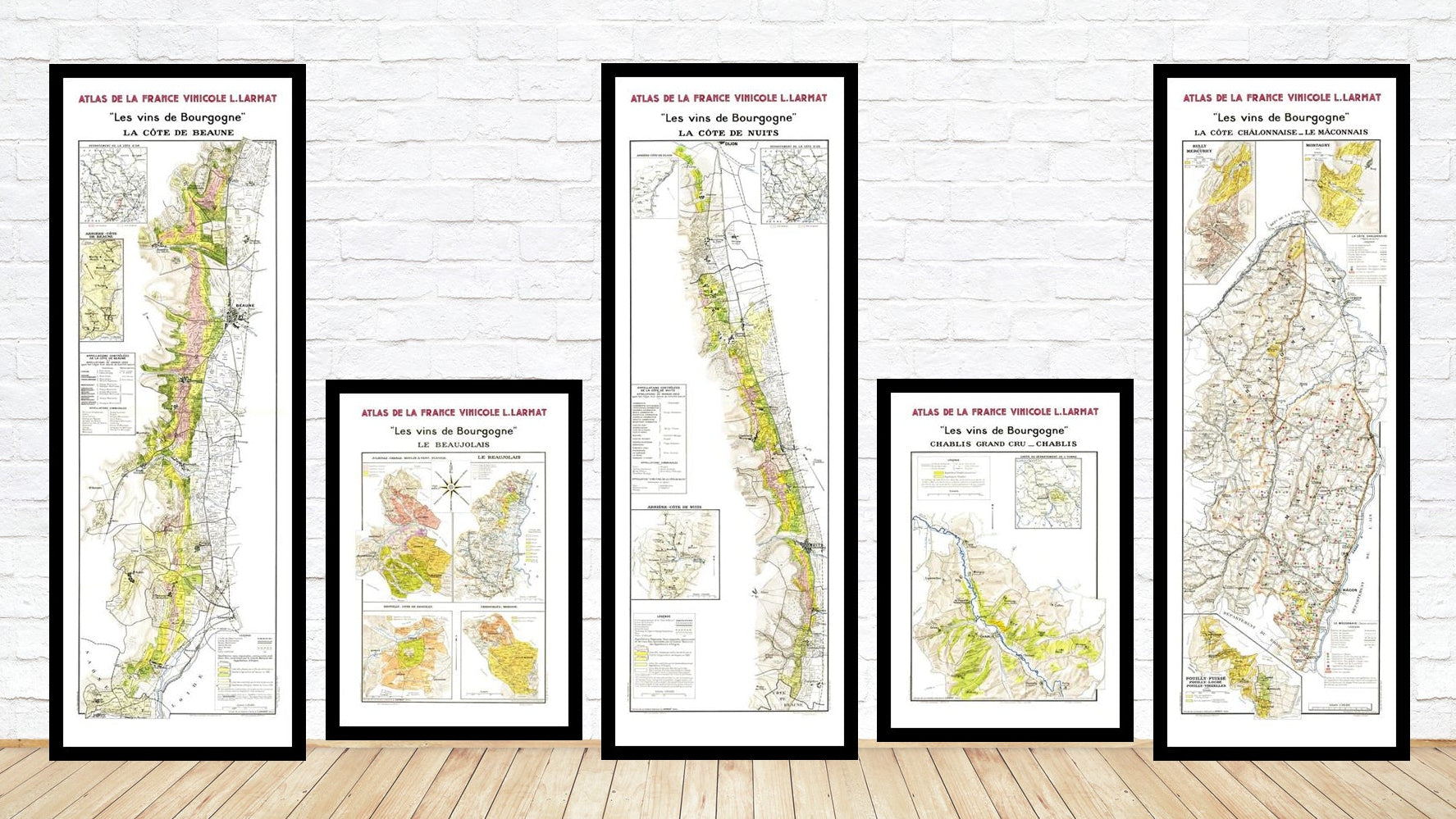 Set of framed maps on a wooden floor with white wall background
