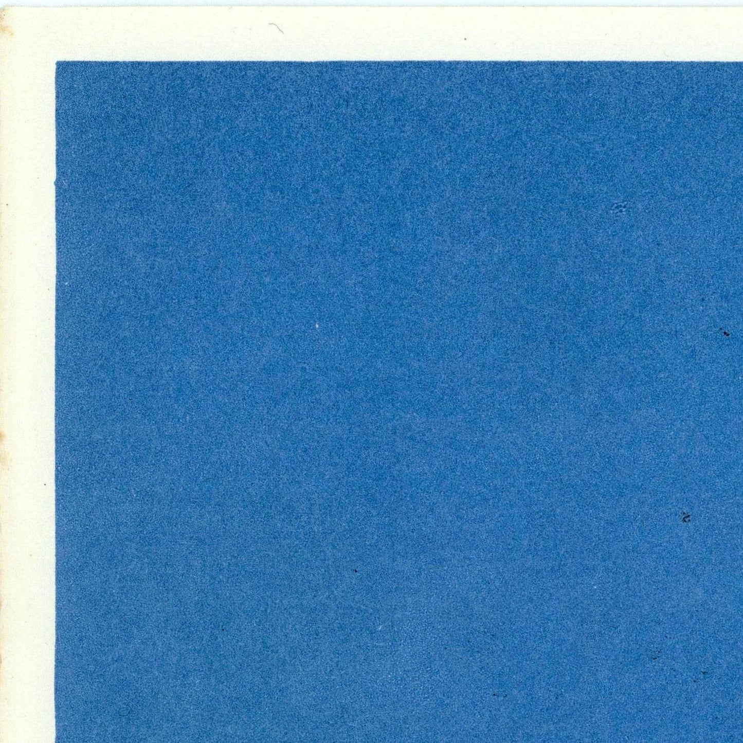 Solid blue color swatch on a textured paper background