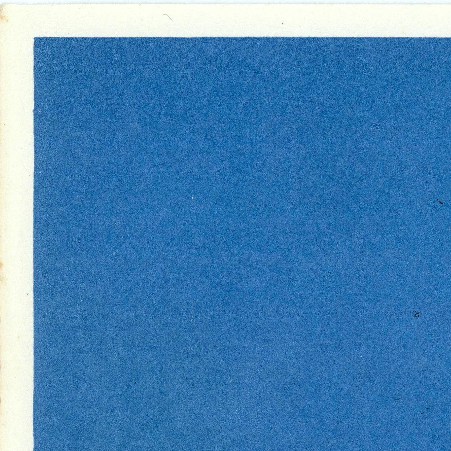 Solid blue color swatch on a textured paper background