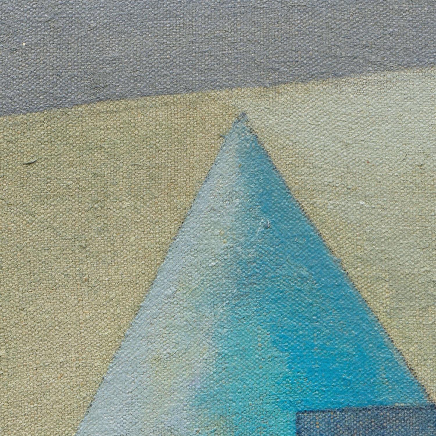 Close-up of a textured surface with geometric shapes in blue, green, and gray.