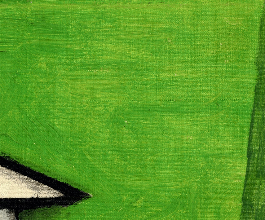 Close-up of a textured green surface with a black arrow pointing to the left.