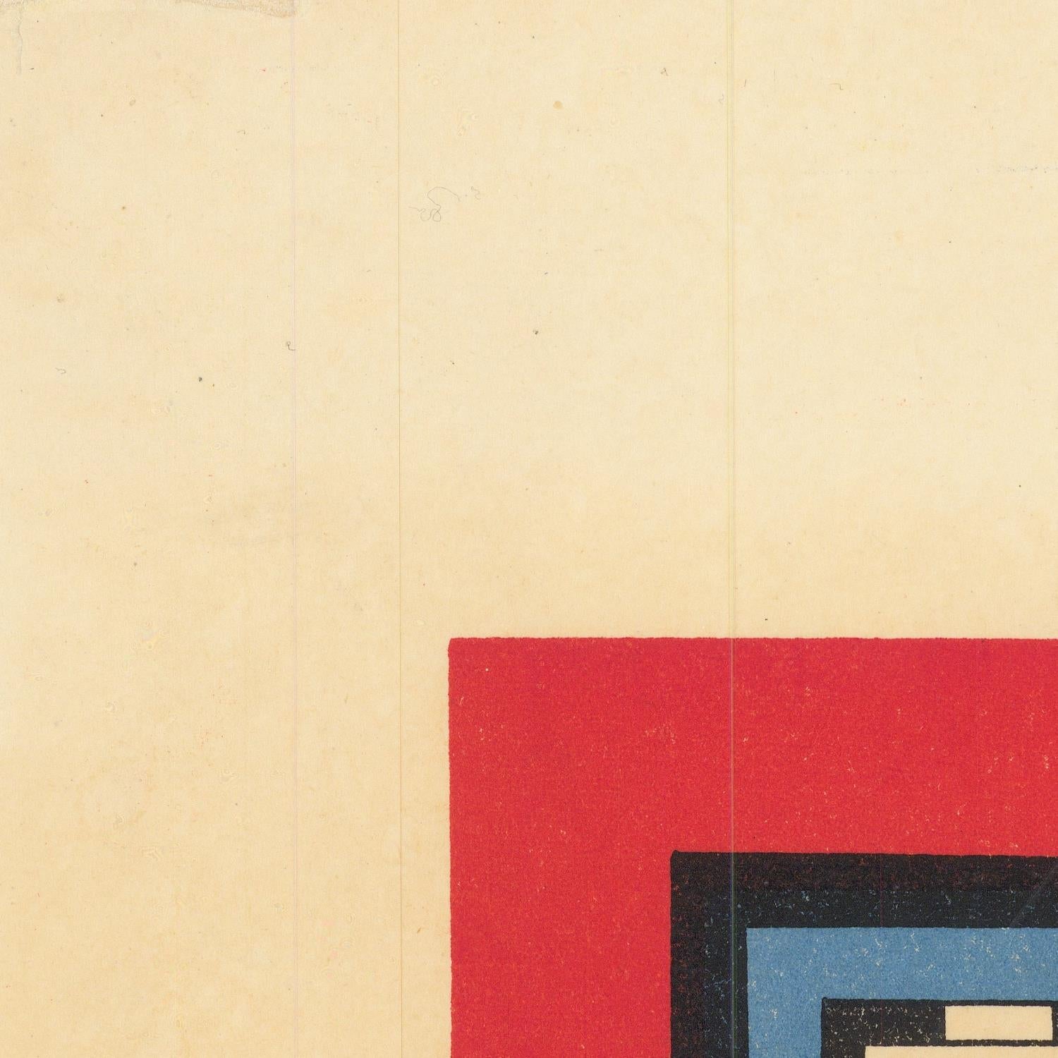 Close-up of a textured beige surface with a red square and geometric shapes.