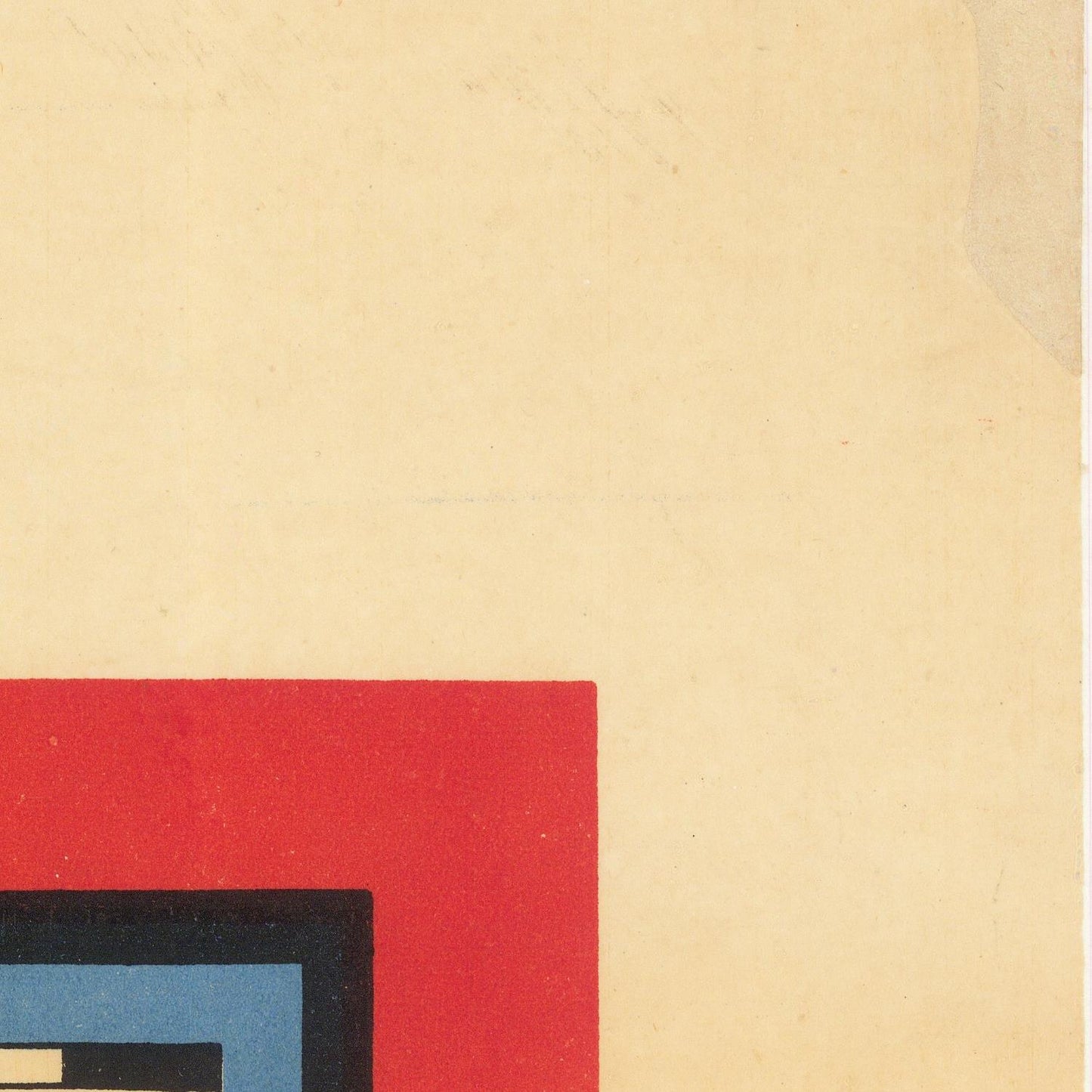 Close-up of a textured beige surface with a red square and black border.