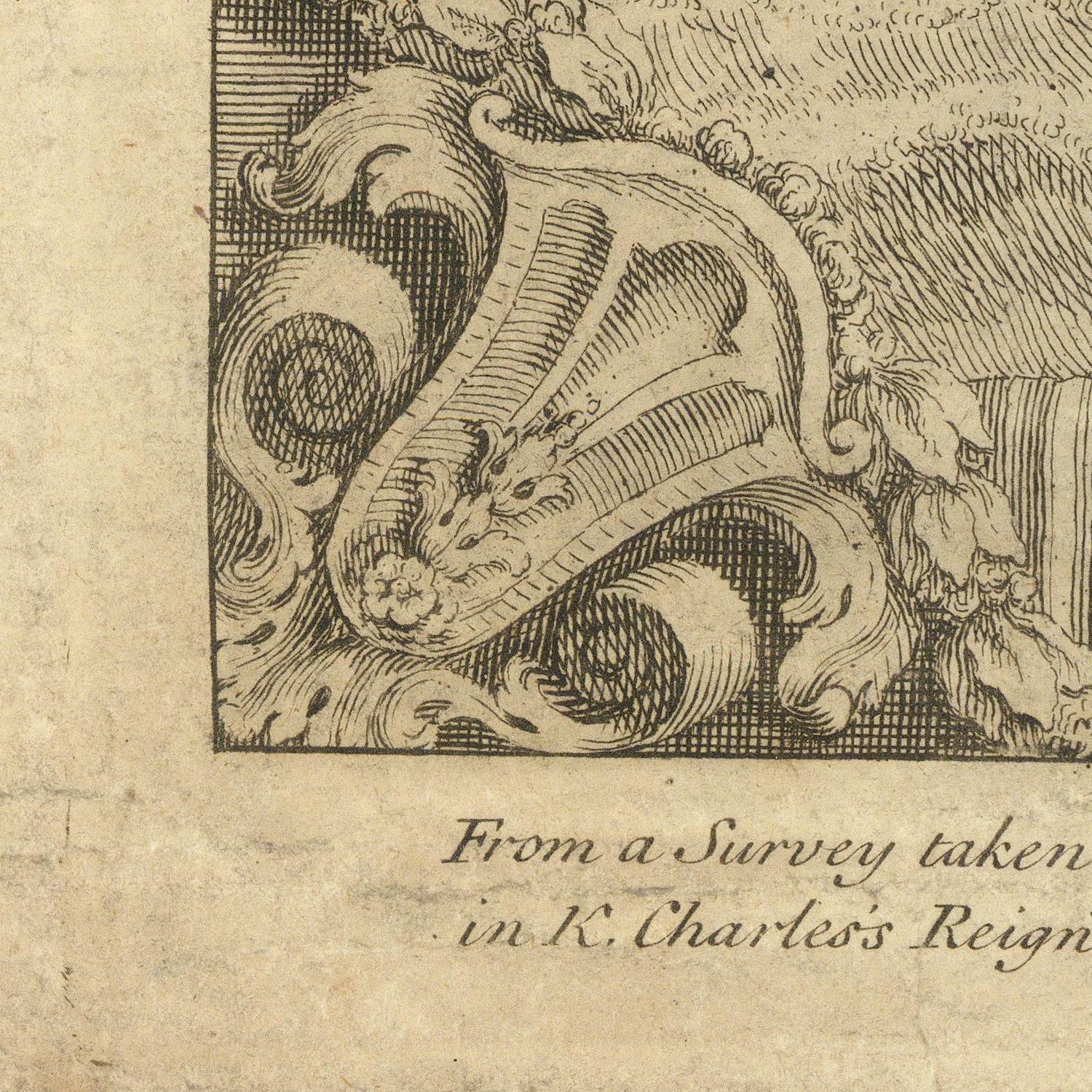 Close-up of an antique engraved print showing part of a decorative crest or animal head in fine linework on aged beige paper, with cursive text below.